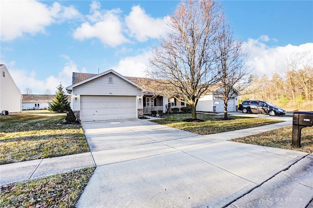 ranch-style home with a porch, an attached garage, concrete driveway, and a front lawn