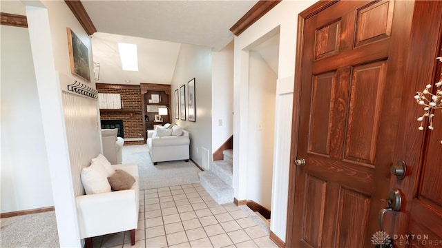 corridor featuring stairway, light tile patterned flooring, baseboards, and light carpet