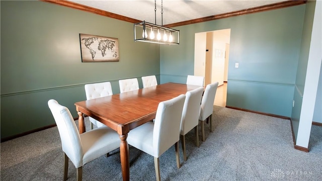 dining space with baseboards, carpet, and ornamental molding