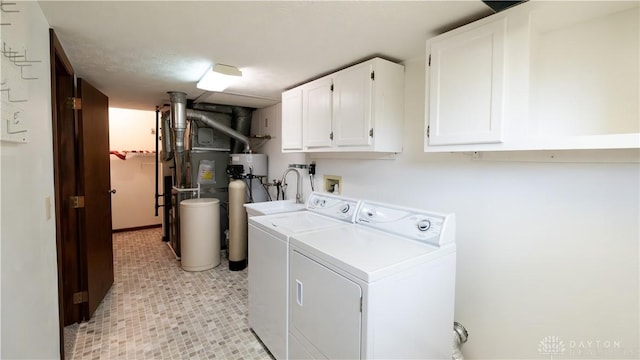 washroom with cabinet space and washing machine and dryer