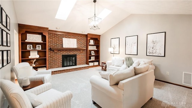 carpeted living room featuring visible vents, lofted ceiling with skylight, built in features, an inviting chandelier, and a fireplace