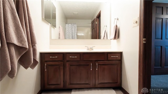 bathroom with vanity and a shower with shower curtain