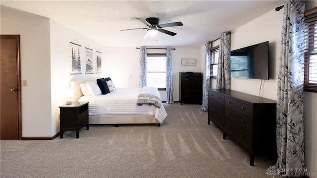 bedroom with light carpet, baseboards, and ceiling fan