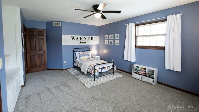 bedroom featuring visible vents, baseboards, carpet, and a ceiling fan