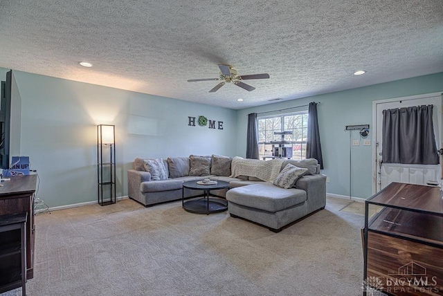 living area featuring baseboards, recessed lighting, ceiling fan, a textured ceiling, and light colored carpet