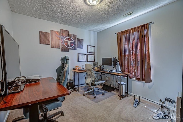 carpeted office space featuring visible vents, a textured ceiling, and baseboards