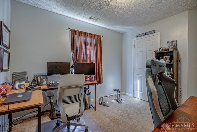 home office with visible vents, a textured ceiling, baseboards, and carpet floors