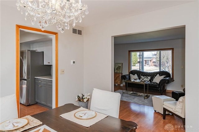 dining room with visible vents and wood finished floors