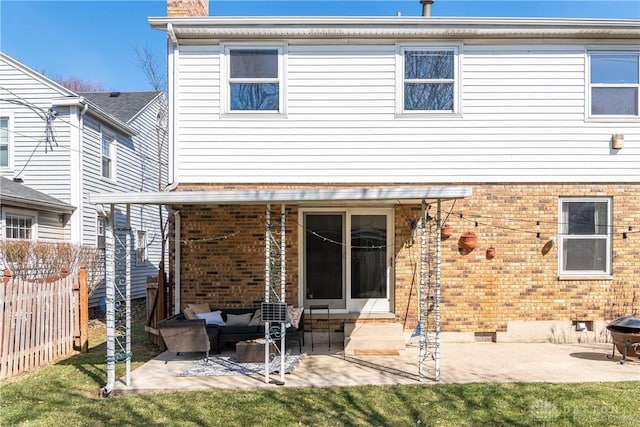 rear view of house with crawl space, a patio, brick siding, and an outdoor hangout area