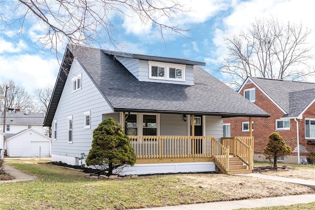 bungalow-style home featuring roof with shingles, covered porch, and a front lawn