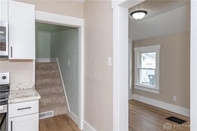 2724 Whittier Ave, Dayton, OH 45420 - stairs featuring visible vents, baseboards, and wood finished floors