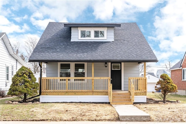 bungalow-style home with a porch and a shingled roof