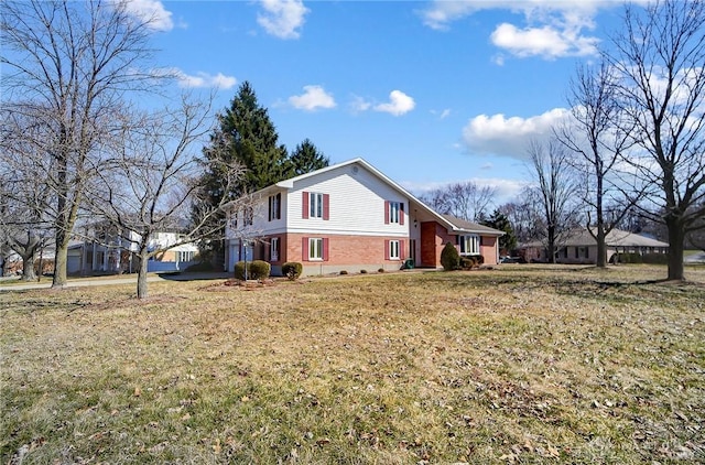 view of property exterior featuring a yard and brick siding