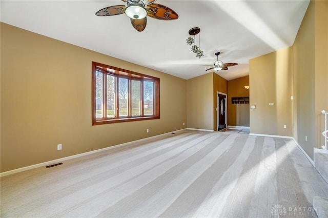 unfurnished room featuring visible vents, ceiling fan, baseboards, and lofted ceiling