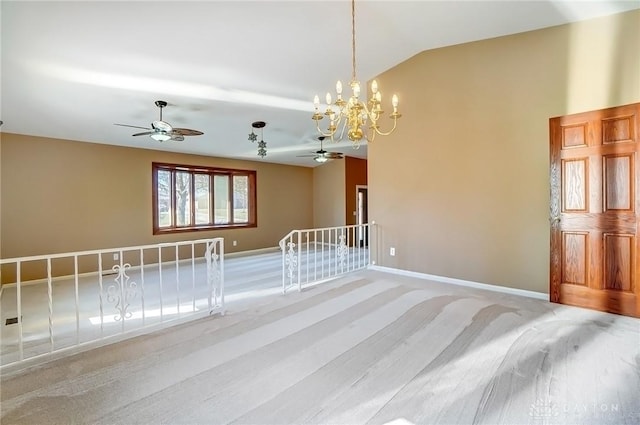 spare room with an inviting chandelier, baseboards, and lofted ceiling