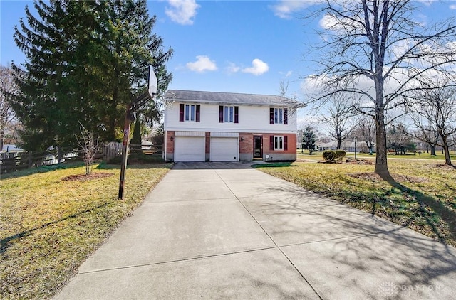 traditional home featuring a front yard, fence, brick siding, and driveway