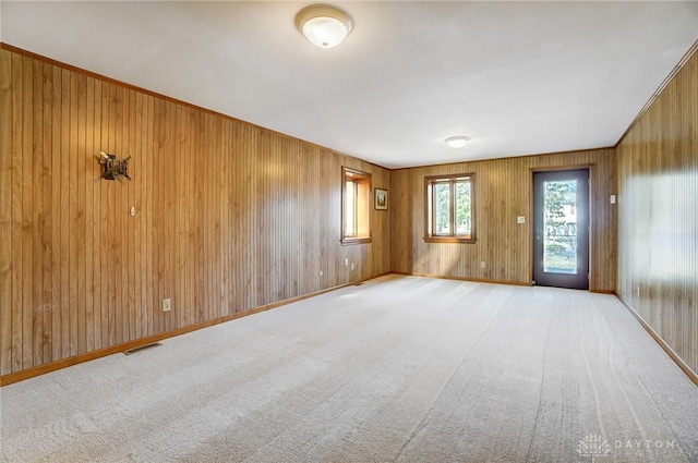 carpeted spare room with visible vents and baseboards