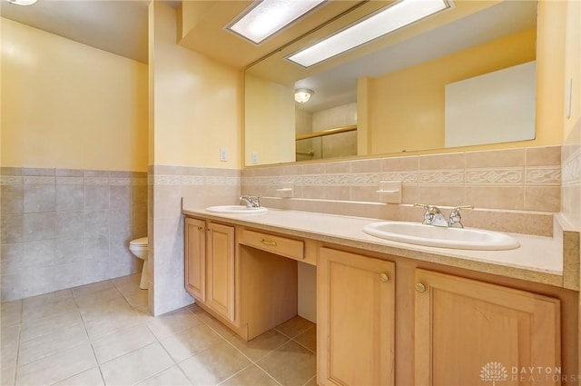 full bath with tile patterned floors, toilet, and a sink