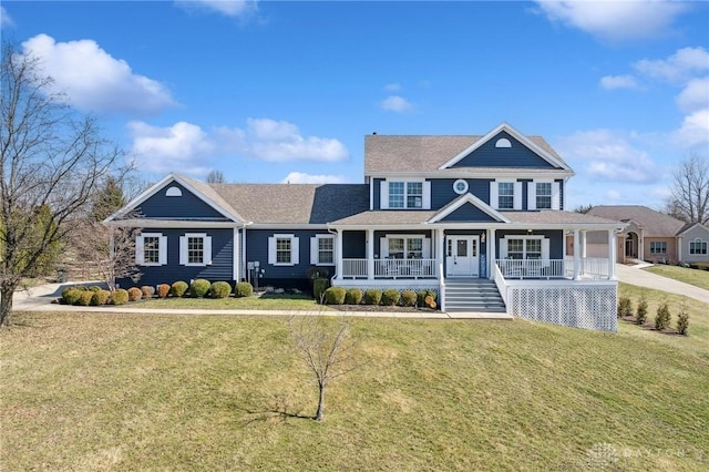 shingle-style home with a garage, driveway, a porch, and a front yard