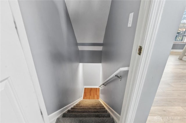 stairs featuring baseboards and wood finished floors