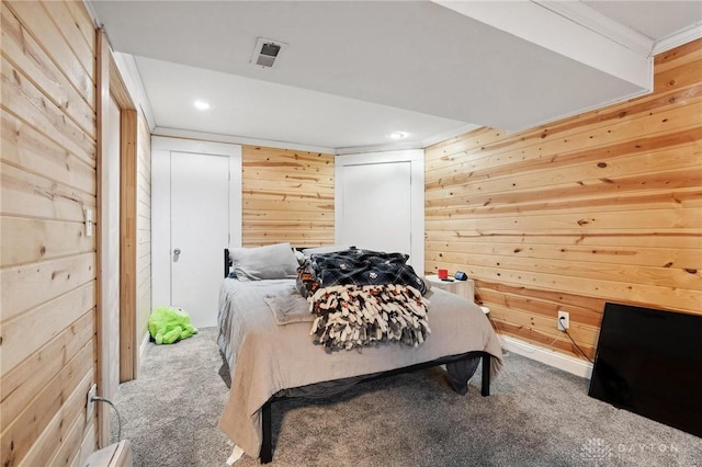 bedroom with recessed lighting, wood walls, carpet, and ornamental molding