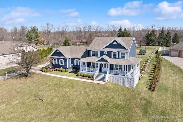 view of front of house featuring a porch, a front lawn, and fence