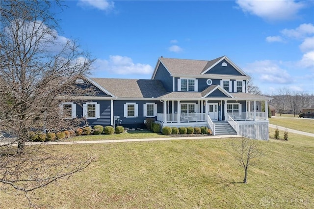 shingle-style home with a porch and a front yard