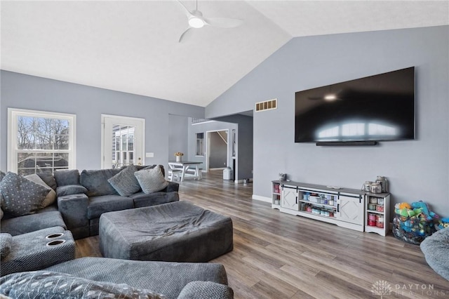 living room featuring visible vents, ceiling fan, lofted ceiling, and wood finished floors