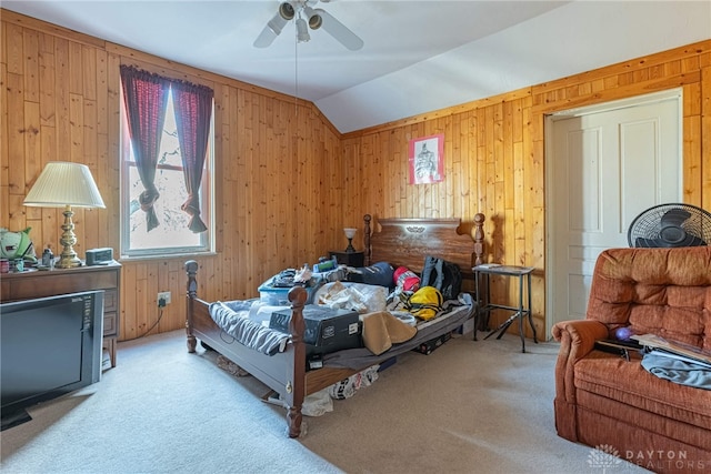 bedroom featuring wooden walls, ceiling fan, carpet flooring, and vaulted ceiling