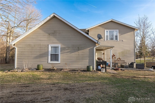 back of house with a yard and central AC unit