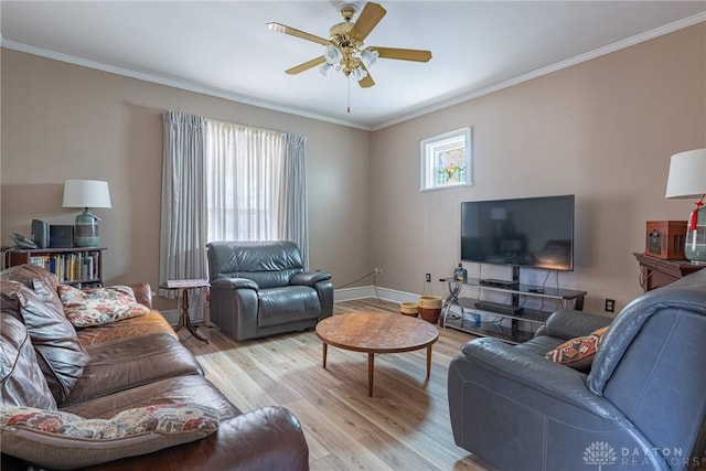 living area with light wood finished floors, baseboards, a ceiling fan, and ornamental molding