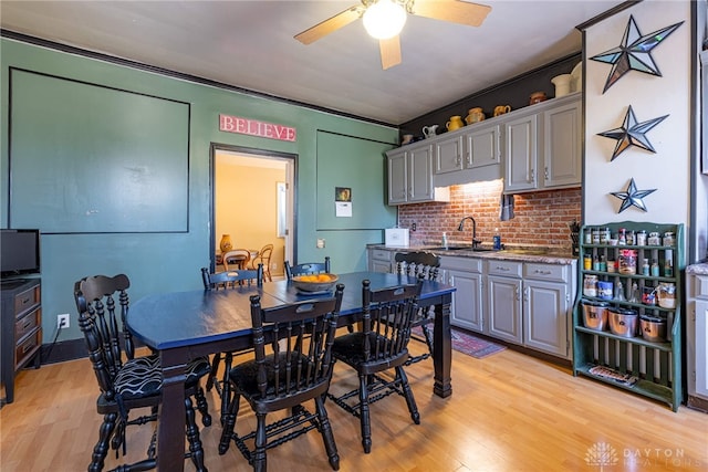 dining space with light wood-style floors and a ceiling fan