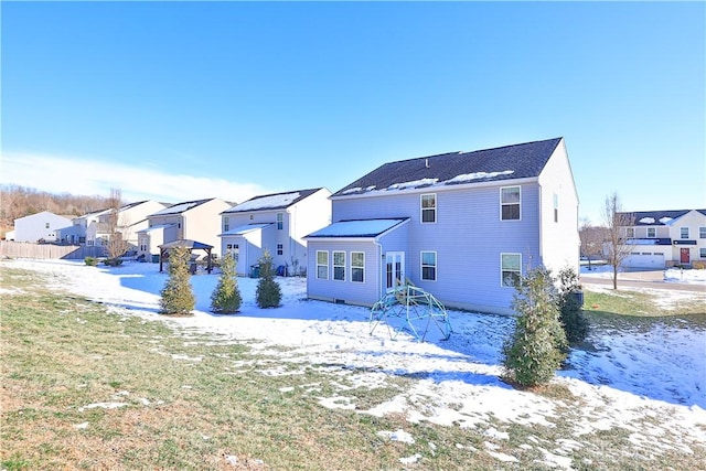 snow covered house with a residential view