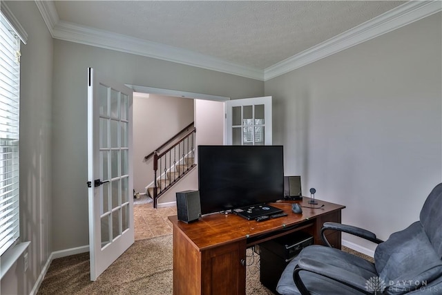 carpeted home office featuring crown molding, french doors, and baseboards