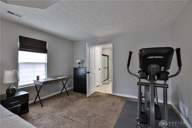 workout room featuring visible vents, carpet floors, a textured ceiling, and baseboards