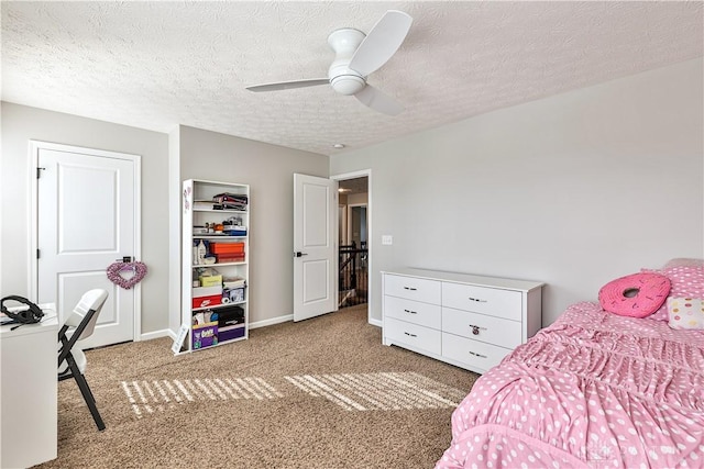 bedroom with ceiling fan, carpet, baseboards, and a textured ceiling