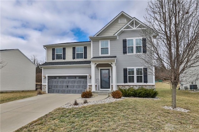 view of front of home featuring stone siding, an attached garage, driveway, and a front lawn