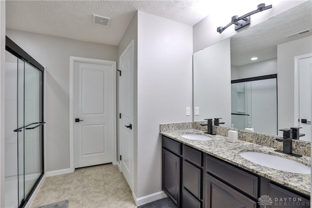 full bathroom featuring a sink, visible vents, and a stall shower