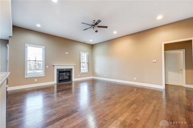 unfurnished living room with wood finished floors, recessed lighting, a ceiling fan, and a premium fireplace