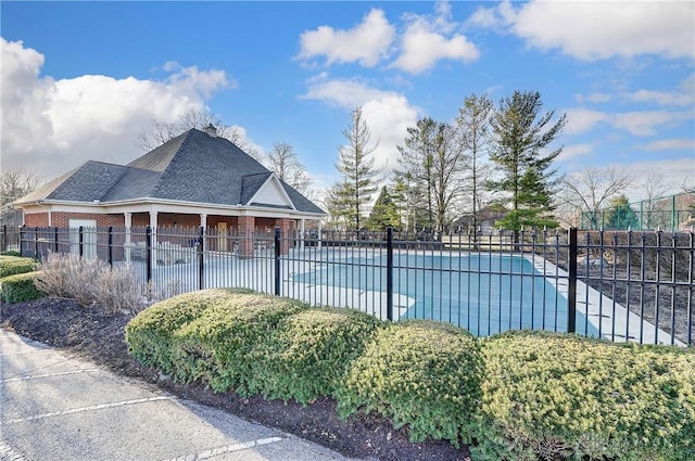 community pool featuring a patio area and fence