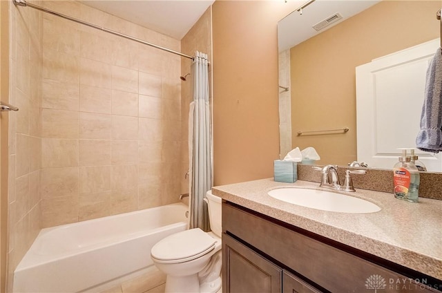 bathroom featuring vanity, shower / bath combination with curtain, toilet, and visible vents