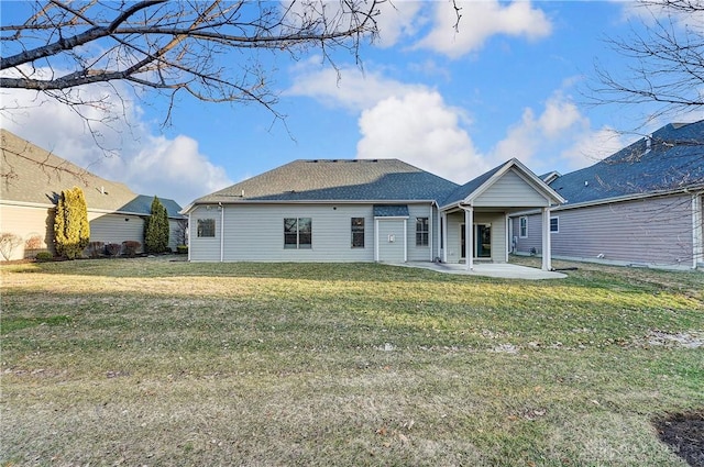 back of house featuring a lawn and a patio