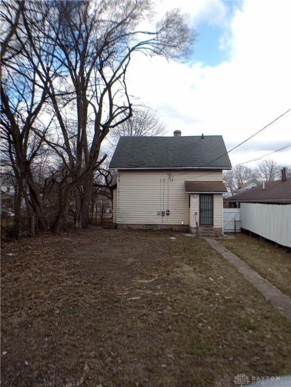 back of house featuring fence