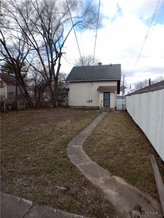 view of yard with entry steps and fence