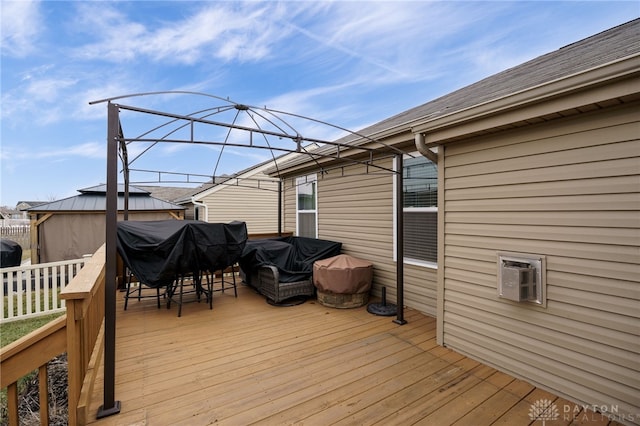 wooden terrace featuring grilling area and fence