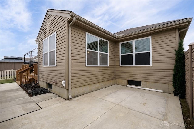 back of property with a patio area and fence