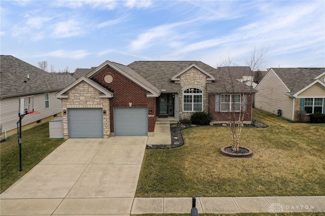 view of front facade featuring a front yard, concrete driveway, brick siding, and a garage