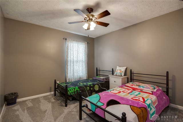 bedroom featuring baseboards, carpet floors, a textured ceiling, and a ceiling fan