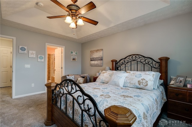 carpeted bedroom featuring a ceiling fan, baseboards, and a textured ceiling