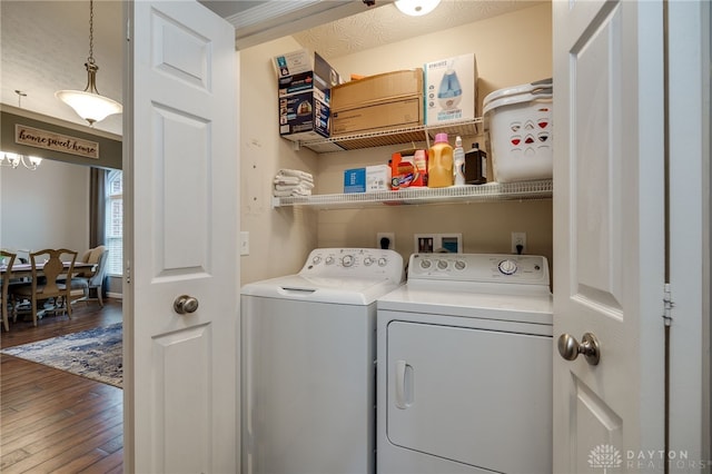 laundry room with wood finished floors, laundry area, and washer and clothes dryer